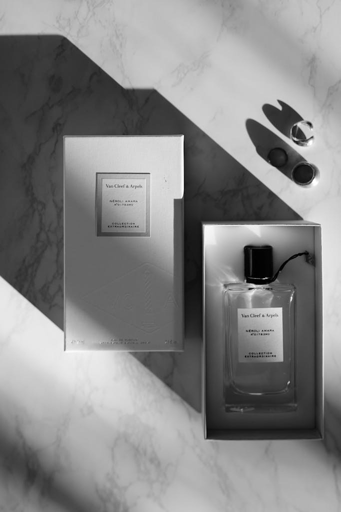 Stunning black and white image showcasing a luxury fragrance bottle on marble surface.
